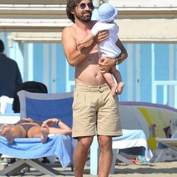 Pirlo con su hijo en brazos por la playa